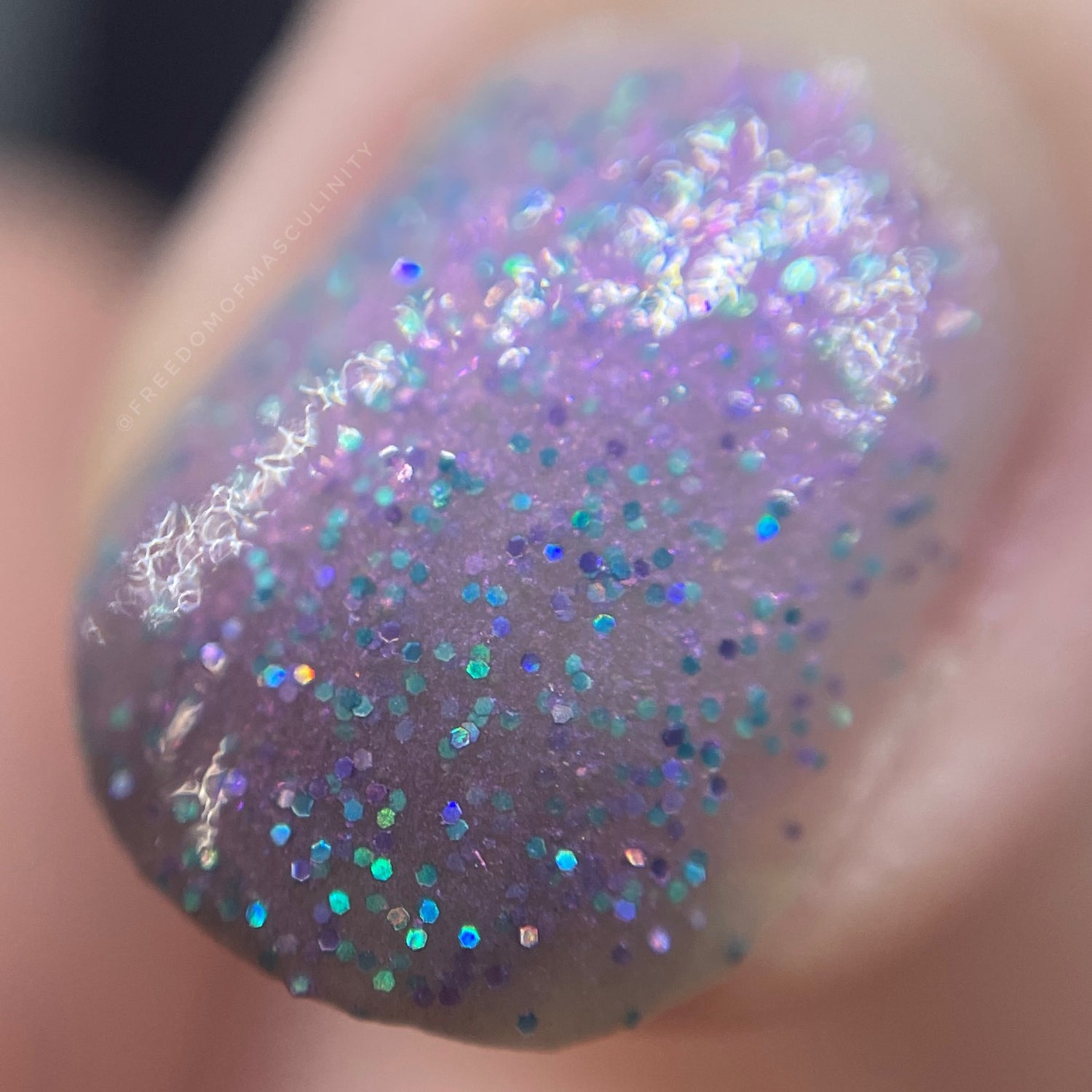 warmer short nails show off holographic flakes on a purple base duotone